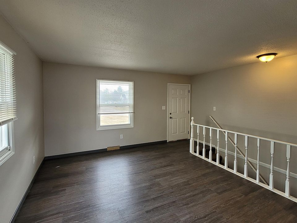 Living Room w/ staircase to Lower Level