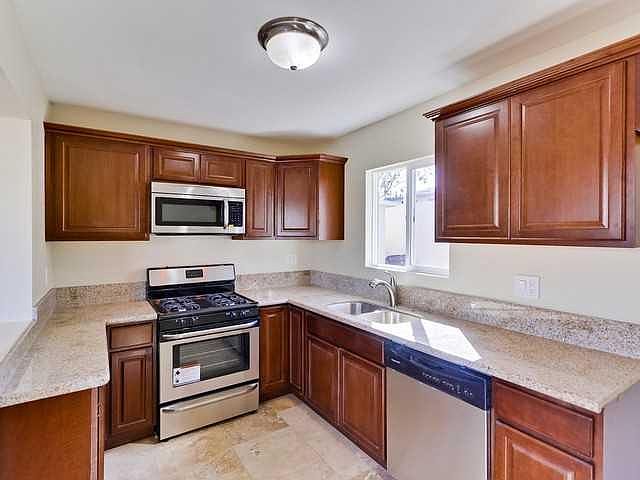 Stainless steel appliances in kitchen. Stainless steel full fridge included.