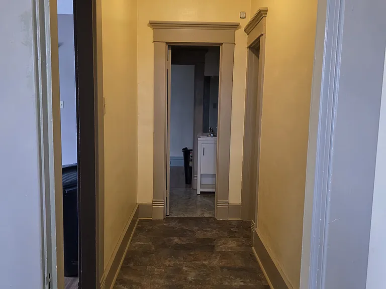 Looking down the hallway going toward the 1/2 bath from the kitchen.