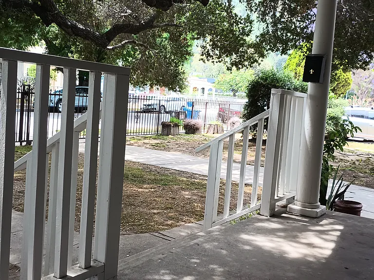 Porch view to street with parking space on site.