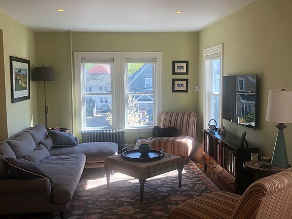 Sun-filled living room with high ceilings