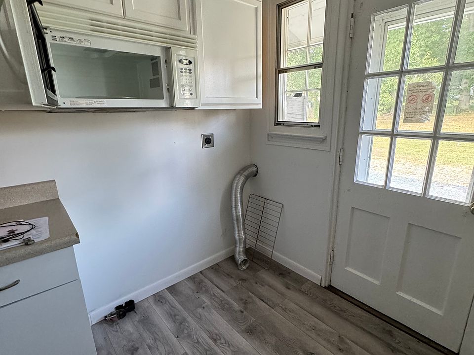 Washer and dryer hook up. Microwave is open due to being cleaned