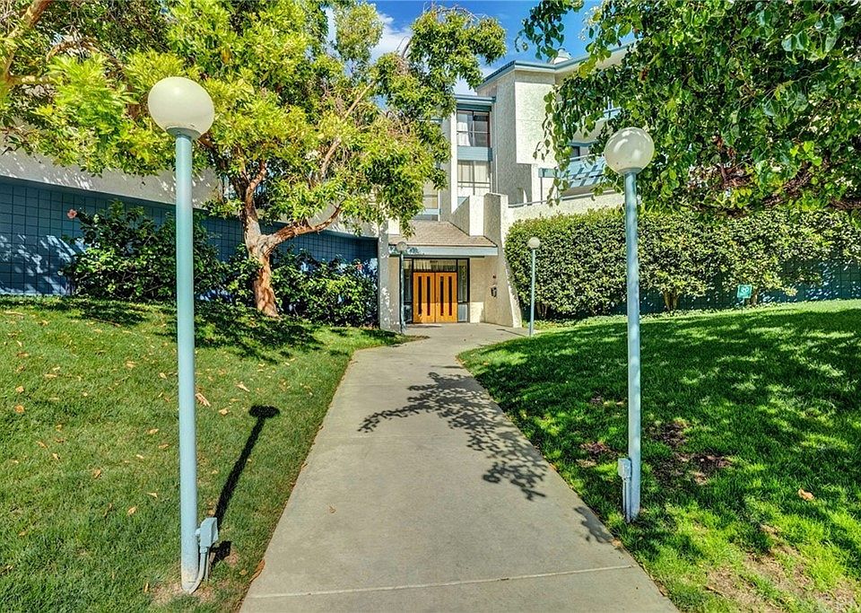 Beautifully landscaped walkway leading to the main entrance, creating a serene and inviting atmosphere.