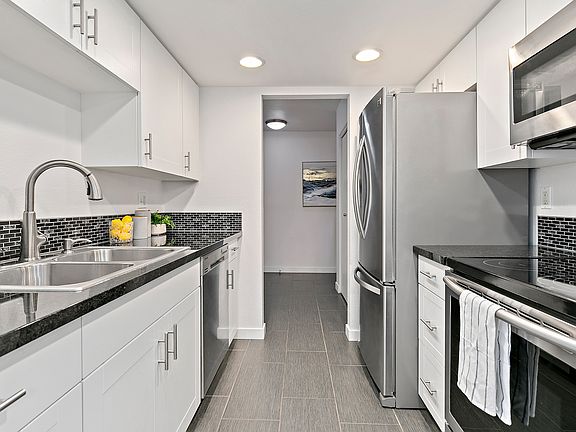 Kitchen with stainless steel appliances and tile flooring