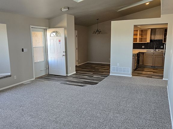 Living room facing kitchen and dining area