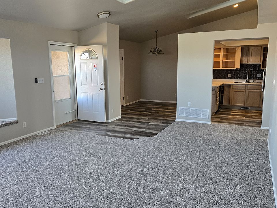 Living room facing kitchen and dining area