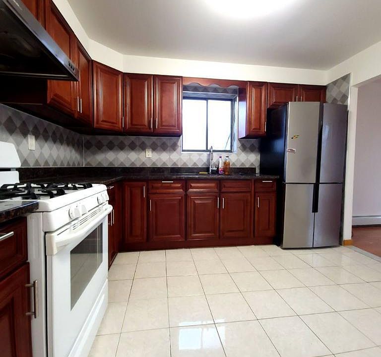 Large, modern kitchen equipped with abundant storage space.