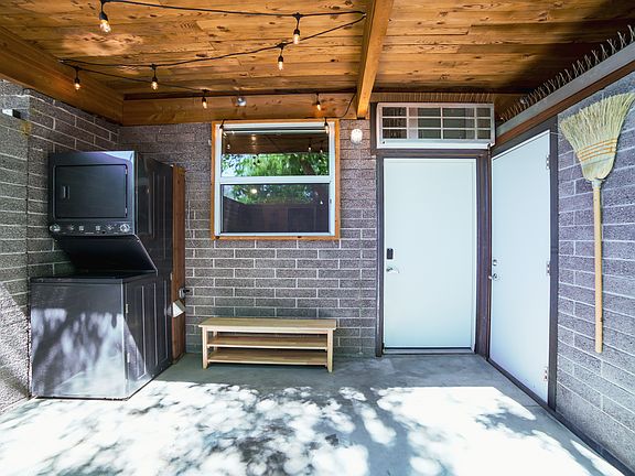 Private patio with washer/dryer and storage room