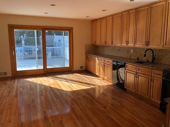 Huge eat in kitchen with sliders to an oversized deck and pool
