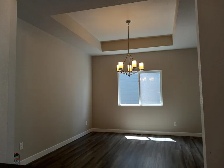 Formal Dining Room, note the tray ceiling, with large opening on the breezeway. Room for a long dining table or formal living room.