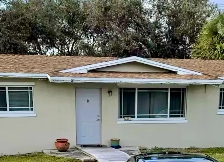 Front of home, circular driveway, large front and back yard.