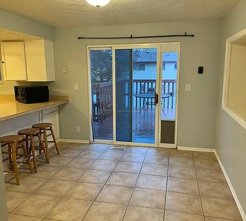 Dining area/ Doggy door and sliding glass door to lead outside.
