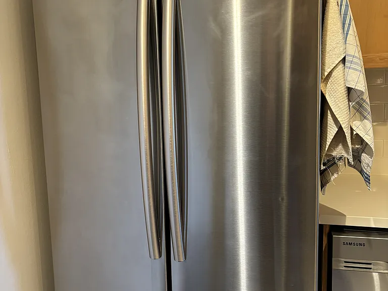 Samsung fridge, with spatious doors and two rows of freezer space in the bottom pull out. The freezer makes ice inside.