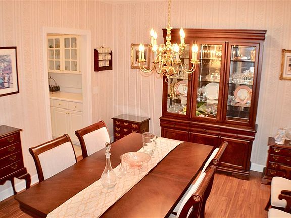 Dining Room Offers crown moulding, skylight (1st of three) and laminent flooring.