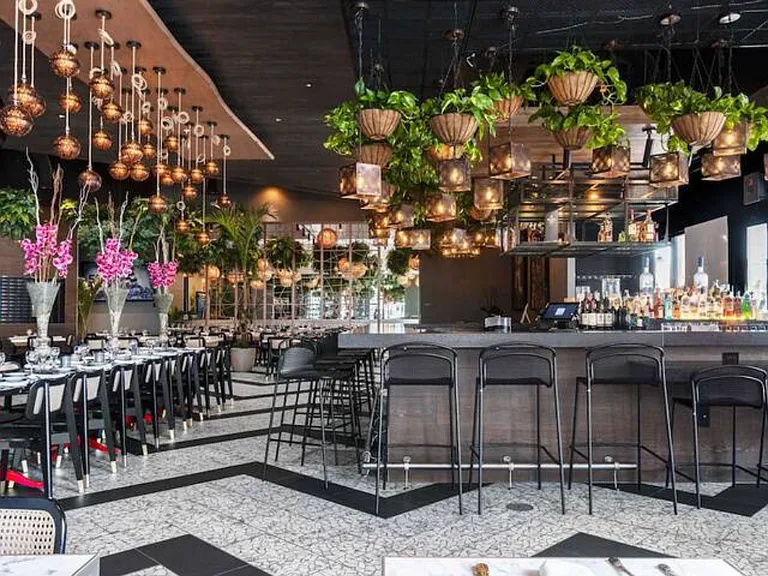 Magical Disney World Proximity - Just 7.5 miles to Animal Kingdom, Margaritaville Orlando, Promenade at Sunset Walk, and Gloria Estefan's Kitchen with Live Music 6 nights a week (Tue-Sun), as shown in this photo.