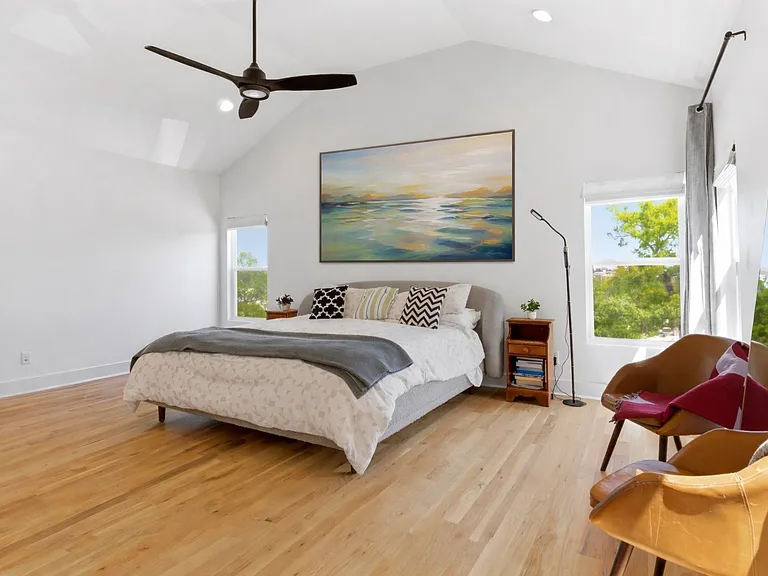LARGE primary suite with downtown views and a vaulted ceiling.