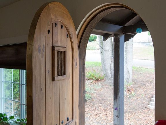 Rounded front door with barred window