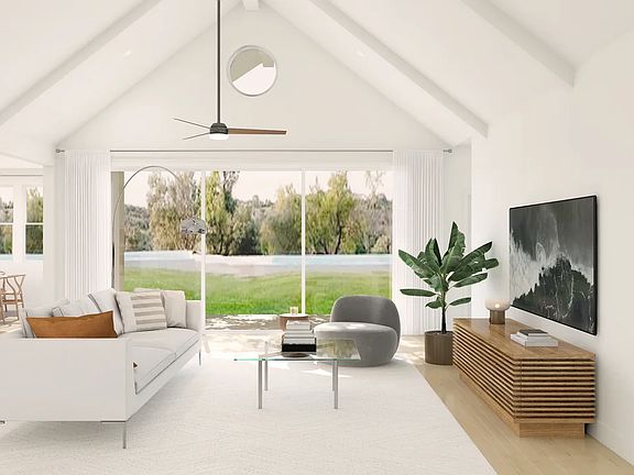 Great room with vaulted ceiling and white ceiling beams