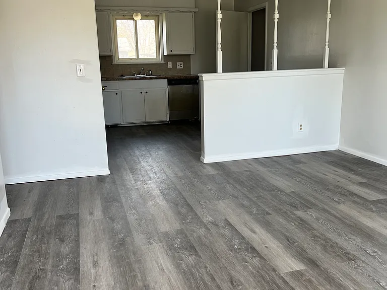 living room facing the kitchen new flooring, new paint