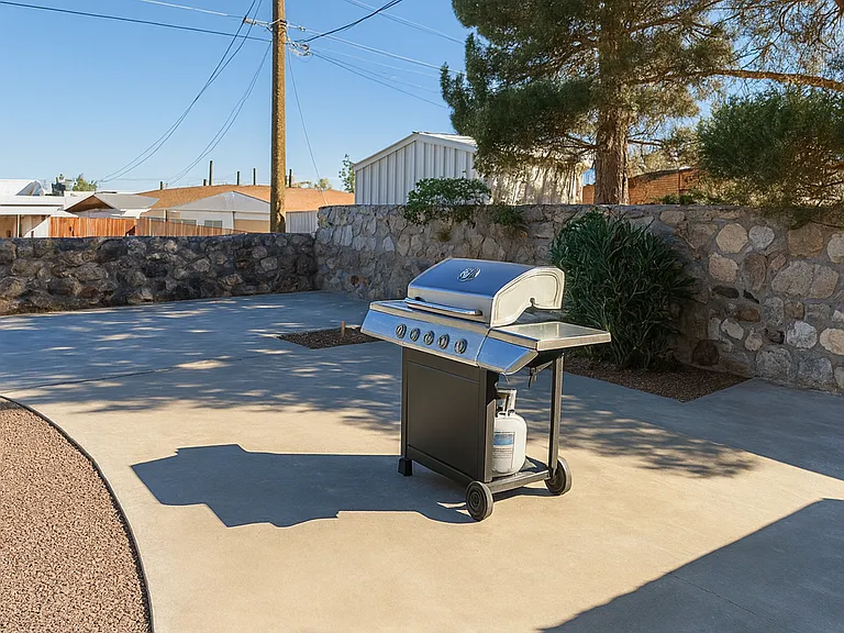 Gas grill and outdoor kitchen area ready for BBQ nights.