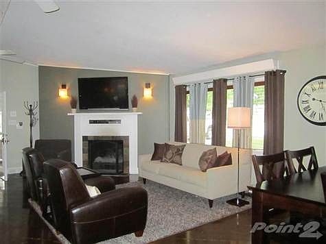 Huge living area with a wood burning fireplace and an insulated compartment for your TV and stereo c