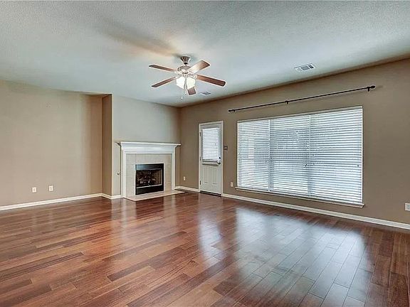 Large family room with fireplace, wood flooring