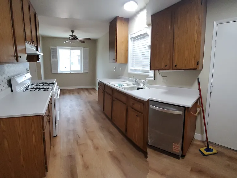 Kitchen showing dining area at the end with new whirlpool dishwasher