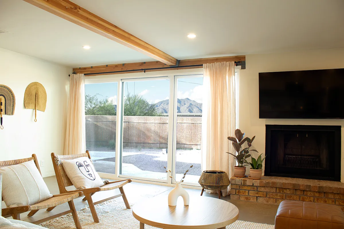 Light-filled living room with fireplace and seamless indoor-outdoor access. - 5341 E Peach St