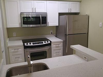 Kitchen appliances are nicely laid out for cooking. Center island is open for entertaining.
