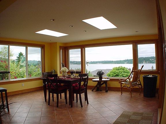 Dining room is surrounded by windows to the Lake and Mtns.