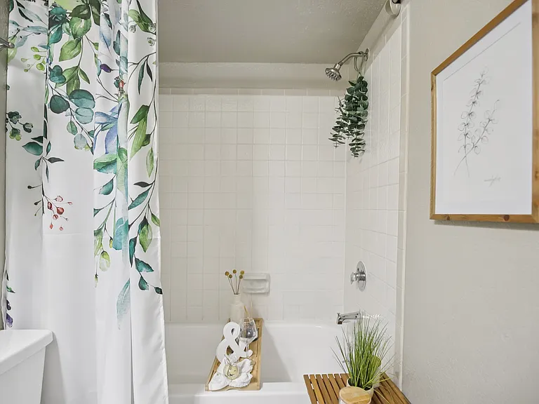 One bedroom bath with tile surround.