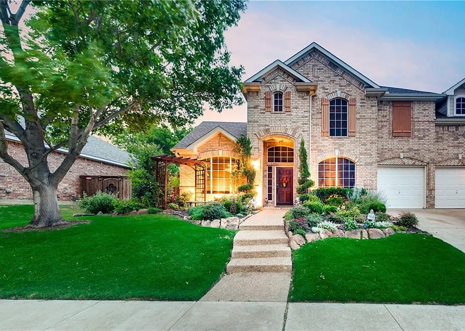 Beautiful drive up with ample professional landscaping, gorgeous tree and front elevation!