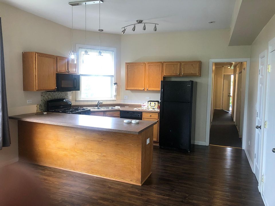 Kitchen area with plenty of cabinet storage, adjustable lighting and work area