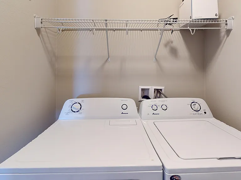 The Poppy studio apartment includes an in-home washer and dryer in a designated laundry and utility room. The Poppy studio apartment includes an in-home washer and dryer in a designated laundry and utility room.