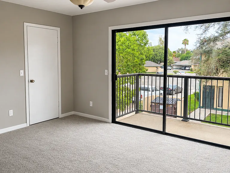 Primary bedroom features a sliding door that opens to a private balcony, perfect for enjoying your morning coffee.