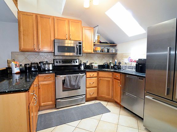 Electric stove with 4 burners and a warmer, convection oven, spacious fridge, large cabinets, high-efficiency two leveled dishwasher, garbage disposal, and bright prep-space with skylight!