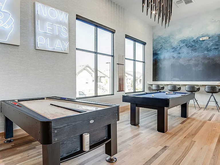 The Wright's entertainment lounge features billiards, shuffleboard, and modern gathering spaces designed for connection and everyday recreation.