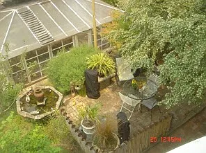 30,000 square feet of outdoor backyard space w/greenhouse and dining table built into it