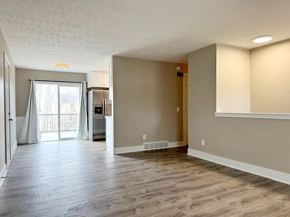 Living and dining area with slider access to private patio