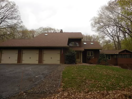 Front of private home on 5 acre wooded lot. Heated 3 car garage with extra storage. - 5400 Vagabond Ln N