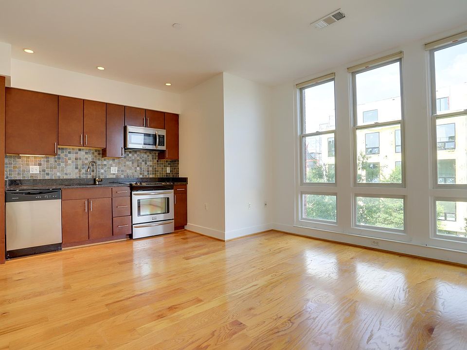 Living area/kitchen with floor to ceiling windows