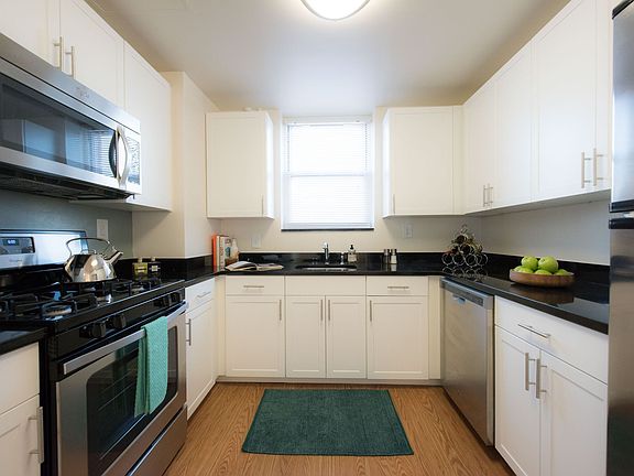 Renovated kitchen with stainless steel appliances and granite counters