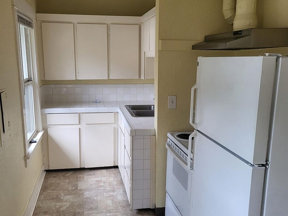 Kitchen has new quartz countertop, sink and faucet