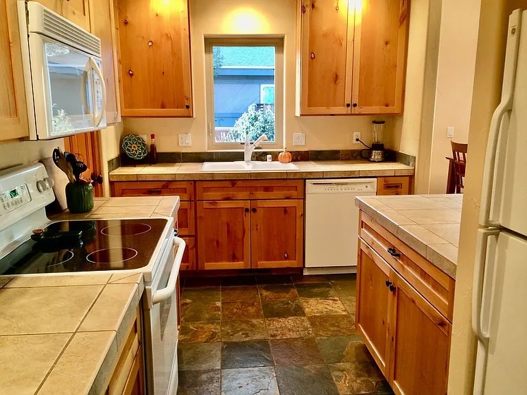 Main level kitchen with a view of the xeriscaped garden. Laundry off the kitchen.