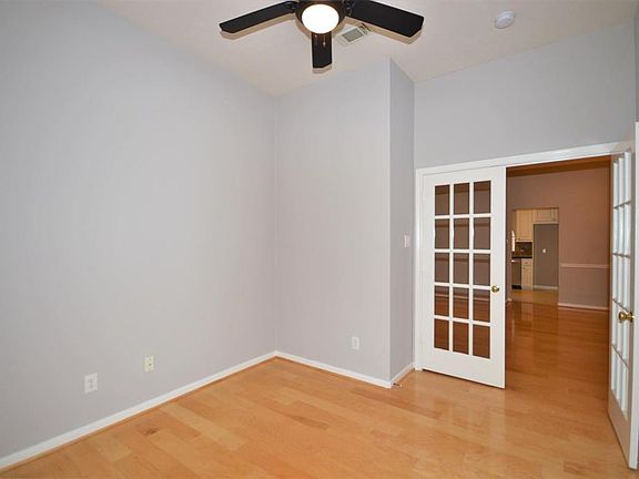 Study with updated ceiling fan, fresh paint, beautiful flooring, and french doors.