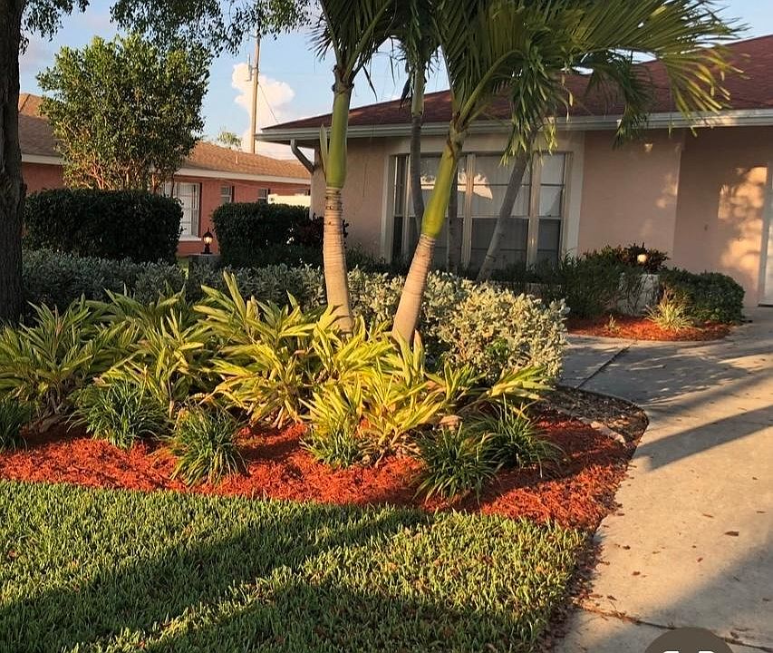 Mature mahogany trees and triple palms provide shade and privacy.