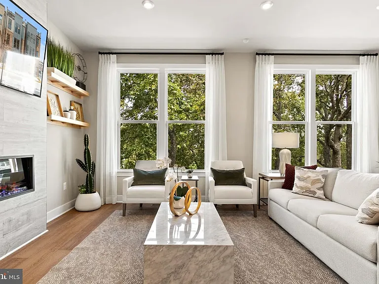 Airy and open family room area with electric fireplace.