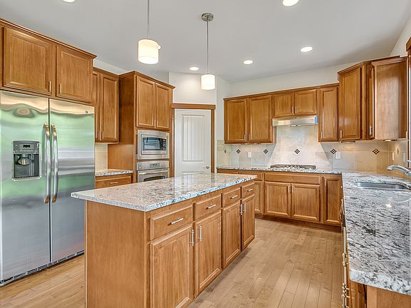 This elegant kitchen offers ample counter and storage space, walk-in pantry, and a central island for cooking, gathering, or simply enjoying your morning coffee.