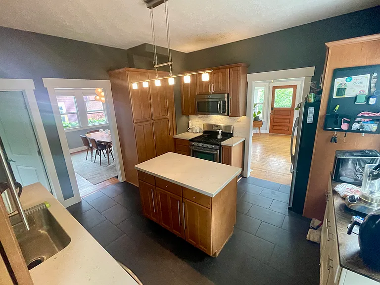 The kitchen flows into the dining room and the foyer.