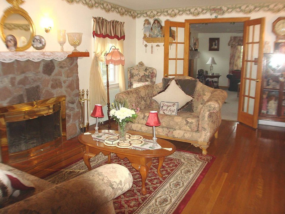 LIVING ROOM WITH WOODBURNING FPL